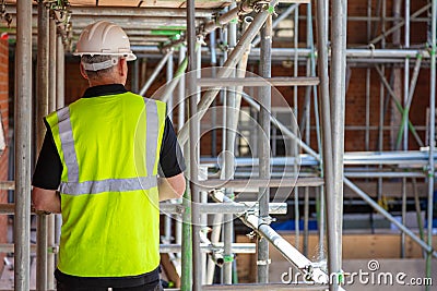 Rear View of a Builder, Architect or Construction Worker on Building Site Stock Photo