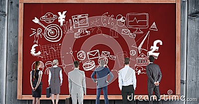 Rear view of business people looking at various symbols on red bulletin board Stock Photo