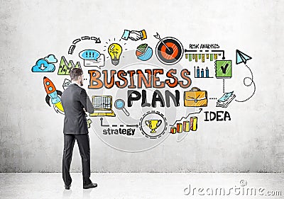 Rear view of businessman looking at business plan Stock Photo