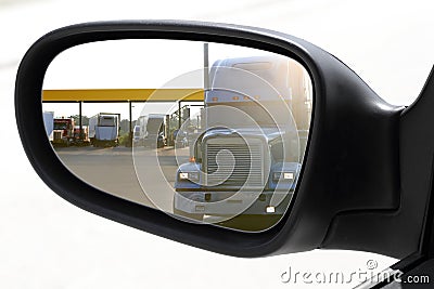 Rear view car driving mirror overtaking big truck Stock Photo