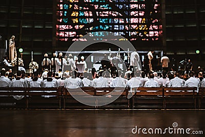 Mass in a Cathedral with many novices on the wooden benches Editorial Stock Photo