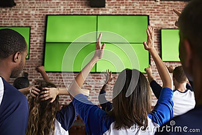 Rear View Of Disappointed Friends Watching Game In Sport Bar Stock Photo