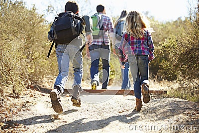 Rear View Of Family Hiking In Countryside Stock Photo