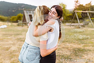 Rear view of girlfriends hugging each other in the countryside. Best friend, love and friendship concept Stock Photo