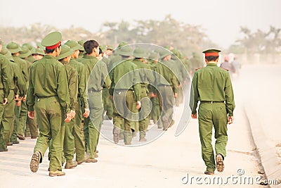 Rear view, a group of Young Vietnamese soldier walking on the street during site visit program of Vietnamese military academies. Editorial Stock Photo