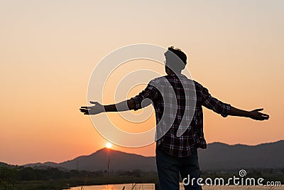 Rear view of happy man spreading arms and watching the mountain. Travel Lifestyle success concept adventure active vacations Stock Photo