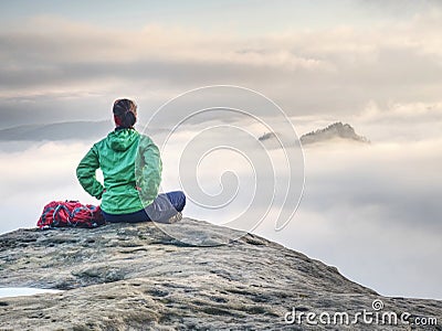 Rear view of hiker woman on top of mountain peak in rocks Stock Photo