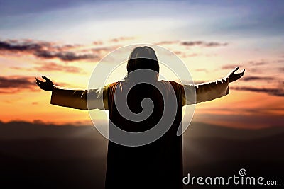 Rear view of Jesus Christ raised hands and praying to god Stock Photo