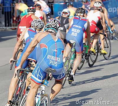 Rear view of large group of male cycling triathlon competitors Editorial Stock Photo