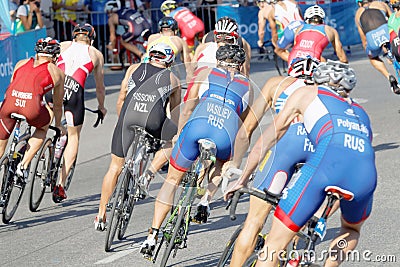 Rear view of large group of male cycling triathlon competitors Editorial Stock Photo