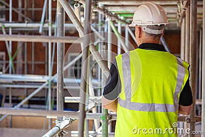 Rear View of a Construction Worker on Building Site Stock Photo