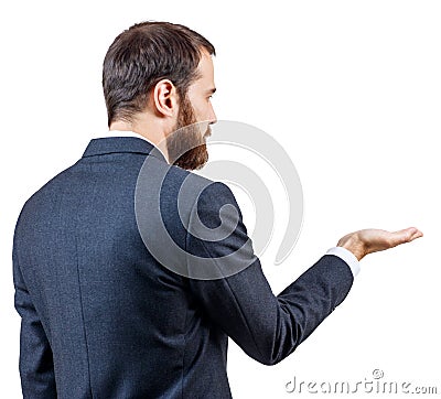 Rear view businessman shows outstretched hand with open palm. Stock Photo