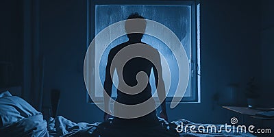 Rear view of man had a terrible nightmare woke up and looked scared, blue light, concept of Psychological distress Stock Photo