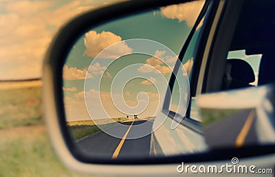 Rear view mirror and long road ahead Stock Photo