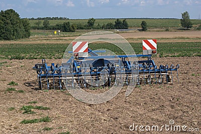 Rear view of a multi-purpose, farm tractor pulled harrow for aerating fields, spreading straw, cultivating stubble and fighting we Stock Photo