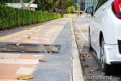 Rear view of new white hatchback car parking on roadside Stock Photo