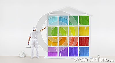 Rear view of painter man pointing with finger the colors house m Stock Photo