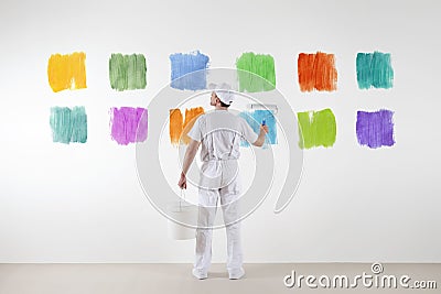 Rear view of painter man who make and chooses from various colors Stock Photo
