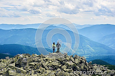 Rear view pair is holding hands and enjoying powerful view Stock Photo