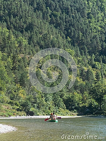 Rear view of People kayaking a kayak in spring river water Stock Photo