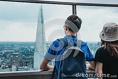 Rear view of people standing on an open air balcony in Sky Garden, London, UK. Editorial Stock Photo