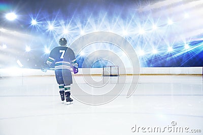 Composite image of rear view of player holding ice hockey stick Stock Photo