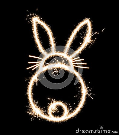 Rear view of a rabbit on a black background is drawn with sparklers, an imitation of a long exposure Stock Photo