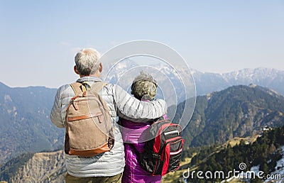senior couple watching the mountains Stock Photo