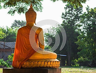 Rear view. Statue of old Buddha meditating beautiful bright gold. Stock Photo