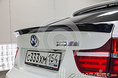 Rear view with tailliamp and spoiler on trunk of luxury very expensive new white BMW X6 M Lumma CLR tuning car stands in the Editorial Stock Photo