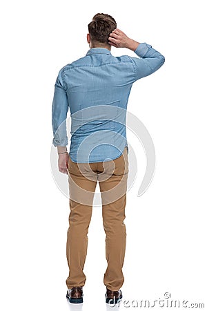 Rear view of a thinking casual man scratching his head Stock Photo