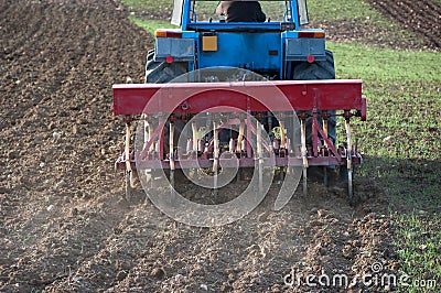 Rear view of tractor with plow Stock Photo