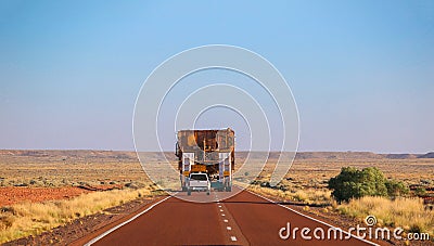 Rear view. Truck oversize rides on road. Load ahead Stock Photo