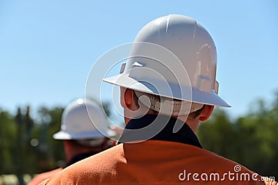 Rear view of two unrecognizable blue collar workers Stock Photo