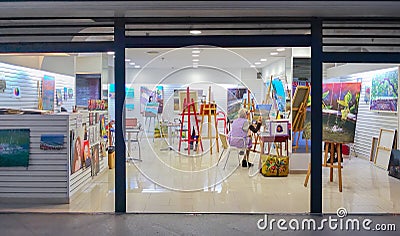 Rear view of woman artist painting picture in studio Editorial Stock Photo