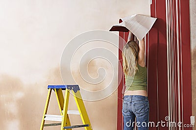 Rear View Of Woman Hanging Wallpaper Stock Photo