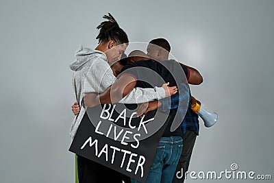 Rear view of young multiracial people hugging each other Editorial Stock Photo