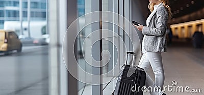 Rear View, Young woman on business trip with her luggage at airport, leaning against the wall and looking at the phone. Generative Stock Photo