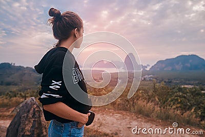 Rear view of a young woman enjoying the awesome view of Ao Phang Nga National Park Stock Photo