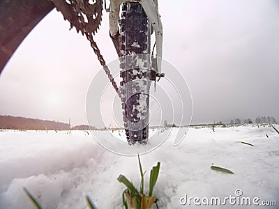 Rear wheel detail of mtb. Snow flakes melting on dark off road tyre. Winter in field. Stock Photo