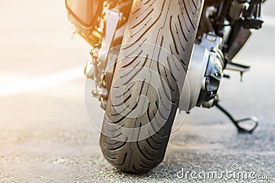 Rear wheel of sports motorcycle on road. Motorbike parked on a s Stock Photo