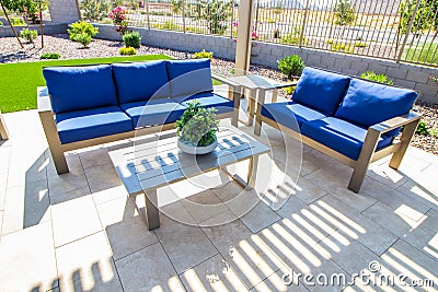 Rear Yard Patio Furniture With Coffee Table & Lounge Couches Stock Photo
