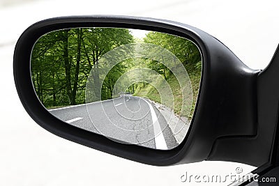 Rearview car driving mirror view forest road Stock Photo