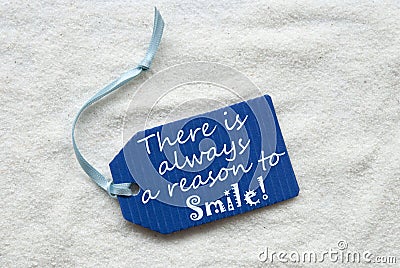 Always Reason To Smile On Blue Label Sand Background Stock Photo