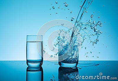 Ð¡reative splashing water in the glass Stock Photo