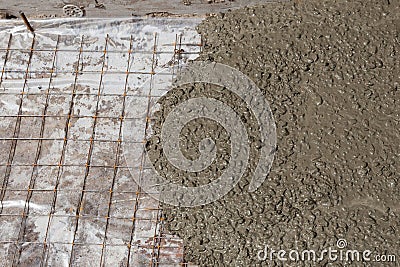 Rebar grids in a concrete floor during a pour. Stock Photo