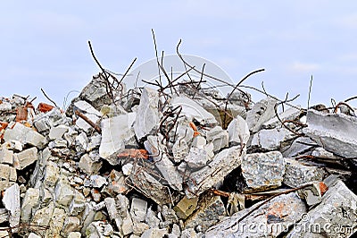 The rebar sticking up from piles of brick rubble, stone and concrete rubble Stock Photo