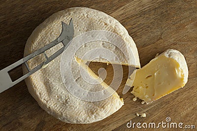 Reblochon de Savoie cheese with a slice Stock Photo