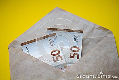 Euro banknotes in white envelope. Open envelope with money banknotes on table. White envelope with Euro money bills. Closeup on En Stock Photo