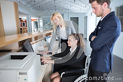 reception female worker in wheelchair Stock Photo